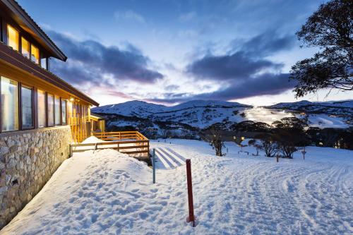 a house in the snow with a view of the mountains at Valhalla Perisher in Perisher Valley