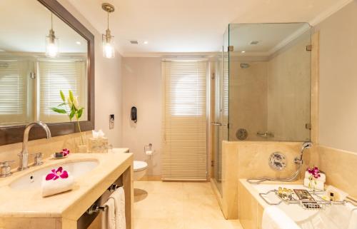 a bathroom with a sink and a shower at Taj Holiday Village Resort & Spa, Goa in Candolim