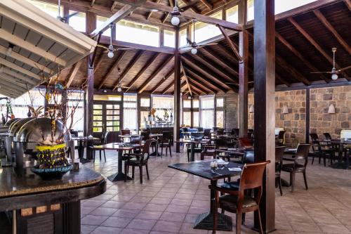 a restaurant with tables and chairs in a building at Abu Dabbab Lodge in Abu Dabab