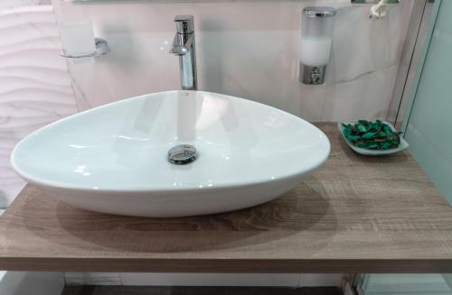 a white sink sitting on a counter in a bathroom at Marranzanu Rooms in Santa Teresa di Riva