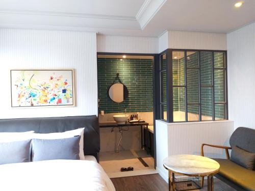 a bedroom with a bed and a table and a chair at Brown Dot Hotel Gyeongju in Gyeongju