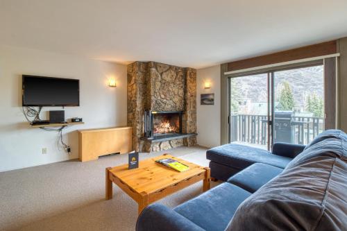 a living room with a couch and a fireplace at 1 Bath Studio Apartment in Snowmass Village in Snowmass Village