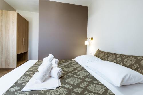 Ένα ή περισσότερα κρεβάτια σε δωμάτιο στο Gregory Comfort Hotel