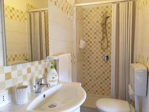a bathroom with a sink and a toilet and a shower at Anastasia Villas-B&B in Lido Signorino