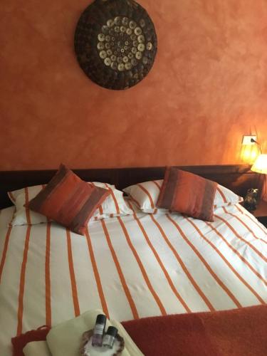 a bedroom with a large bed with two pillows at Il Montetto Mare e Natura in Arcola