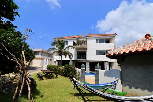 a hammock in a yard in front of a building at Sky Ocean - Ishigaki Eco-Resort - Newly Renovated in Ishigaki Island