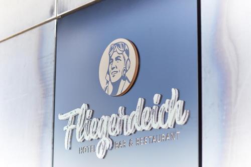a sign on the side of a hotel car dealership at Fliegerdeich Hotel & Restaurant in Wilhelmshaven
