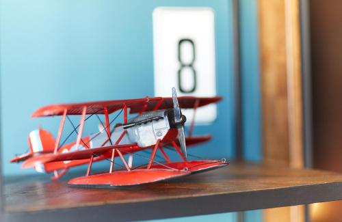 a model of a red model plane sitting on a table at Fliegerdeich Hotel & Restaurant in Wilhelmshaven