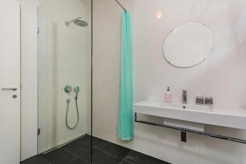 a bathroom with a shower and a sink at Premium Apartment Maj **** in Poreč