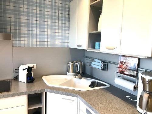 a kitchen with a sink and a coffee maker at Inselferien Micheel in Burg auf Fehmarn