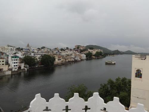 a view of a river with buildings and a city at Karohi Haveli - A Heritage Hotel in Udaipur