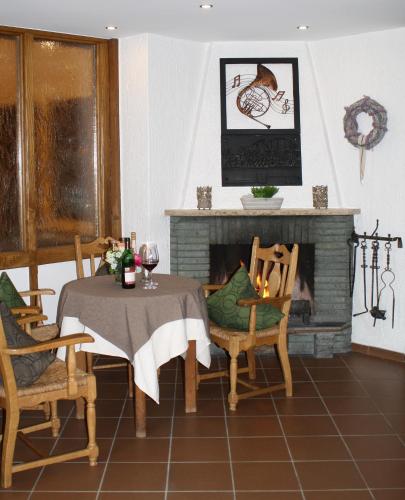 a dining room with a table and a fireplace at Alte - Post - Hotel in Schöppingen