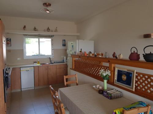 a kitchen with a table and a dining room at Bertha's Coffee in Afula
