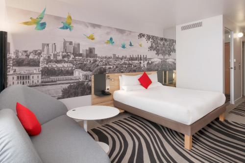 a hotel room with a bed and a couch at Novotel London Excel in London