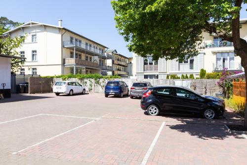 a group of cars parked in a parking lot at Pension Haus Waldesblick in Graal-Müritz