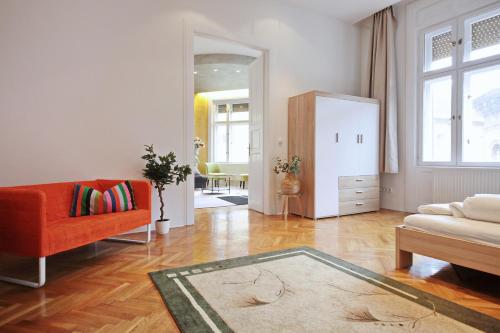 a living room with a couch and a chair at Luxury gold plated suite in calm central location in Budapest