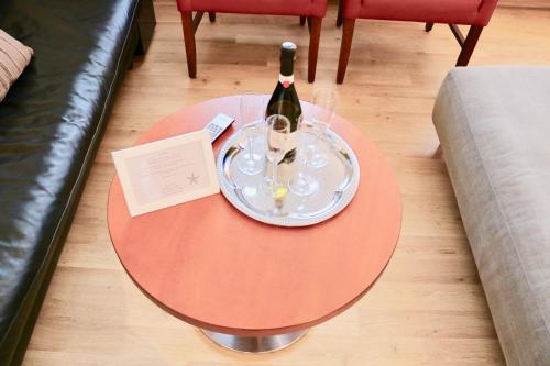 a table with a bottle of wine and glasses on it at Ferienwohnung Seestern in Steinhude, ruhig gelegen , 2 Schlafzimmer, 2 Bäder, Freies WLAN in Wunstorf