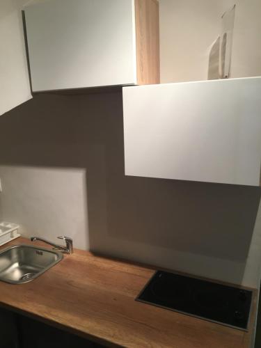 a kitchen counter with a sink and a white cabinet at City Center AP 2 in Košice