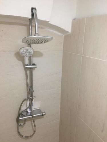 a shower in a bathroom with a shower head at City Center AP 2 in Košice