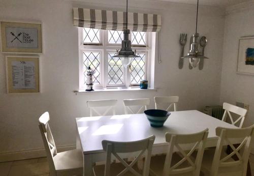 a dining room with a white table and chairs at Sea Lodge Holiday Home by Trident Holiday Homes in Bantry