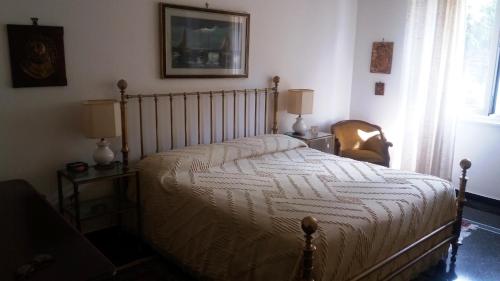 a bedroom with a bed and a chair and a window at b&bEuropa in Genova