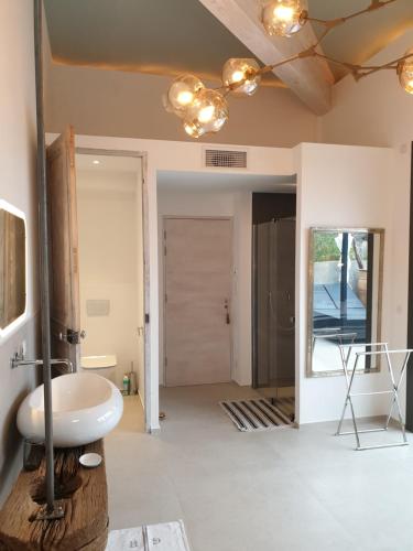 a bathroom with a sink and a mirror at Mas de la Petite Jeanne in Grimaud