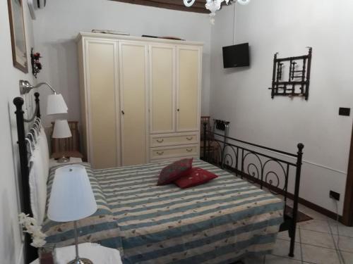 a bedroom with a bed with a red pillow at La Corte in Venice