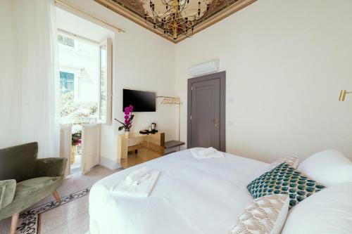 En eller flere senge i et værelse på Palazzo dei Grifoni - Luxury Suites -