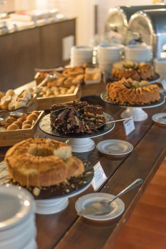 a buffet filled with different types of pies and pastries at Blue Tree Premium São Luis in São Luís