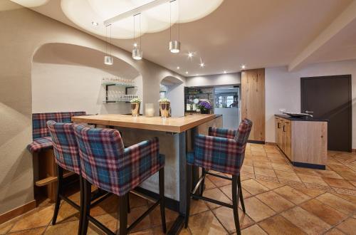 a kitchen with a wooden table and chairs at Hotel Reiler Hof in Reil