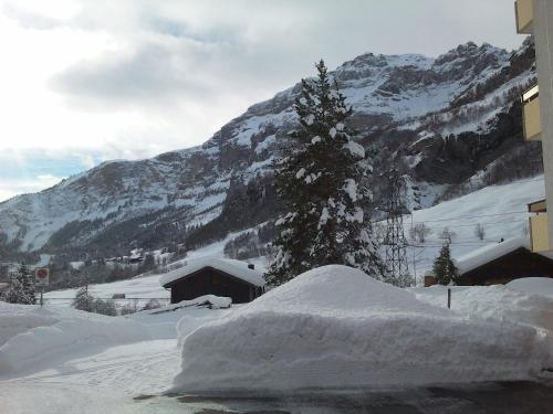a pile of snow in front of a mountain at Baron / Baronesse Apartments in Leukerbad