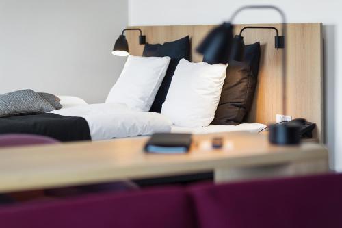 a room with a couch and a bed with pillows at Best Western Plus Hotel Fredericia in Fredericia