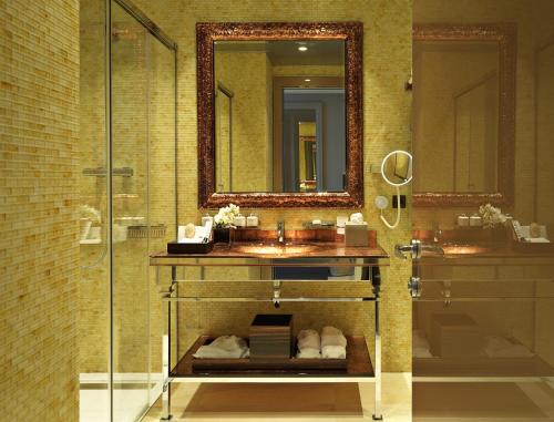 
a bathroom with a sink and a mirror at Alàbriga Hotel & Home Suites GL in S'agaro
