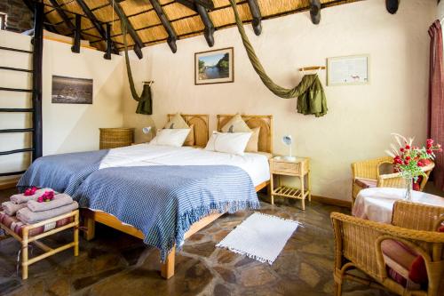 A bed or beds in a room at Etusis Lodge