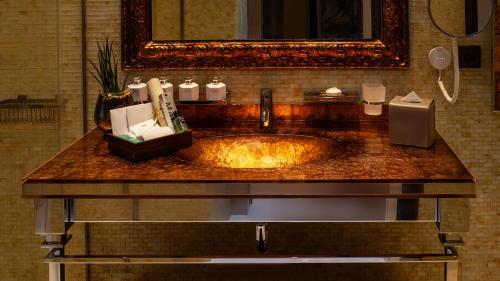 a sink in a bathroom with a mirror at Alàbriga Hotel GL in S'Agaro