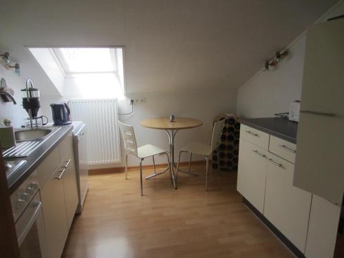 a small kitchen with a table and chairs in it at Weingut Arnold Pauly in Osann-Monzel