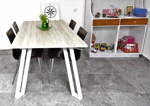 a dining room table with chairs and a wooden table at Casa da Avó Lurdes in Póvoa de Varzim
