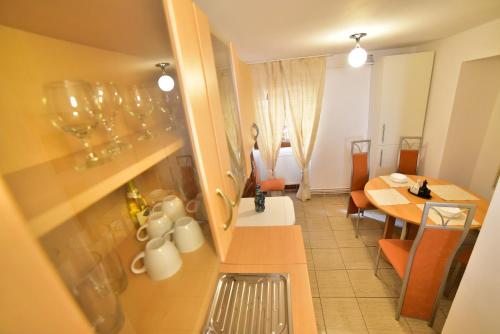 Il dispose d'une cuisine et d'une salle à manger avec une table. dans l'établissement FLH - Emma Apartment, à Sibiu