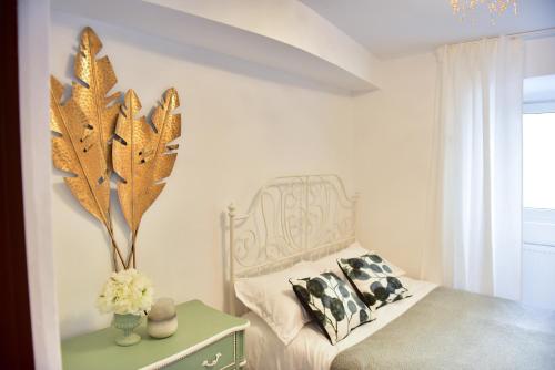 a bedroom with a bed and a vase of flowers at FLH - Emma Apartment in Sibiu