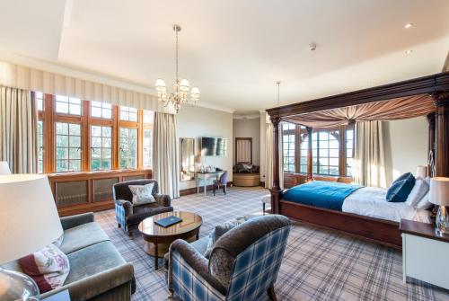 a bedroom with a bed and a living room at Murrayshall Country Estate in Perth
