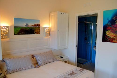 a bedroom with a bed with two pillows on it at Hotel Budoni Beach in Budoni