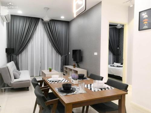 a dining room and living room with a table and chairs at Legoland D'PRISTINE Apartment By TGP in Nusajaya