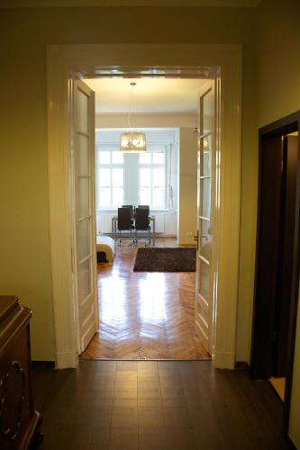 an open door to a room with a living room at Five Season's Apartment in Budapest