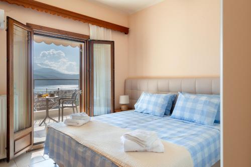 a bedroom with a bed with a view of the ocean at Alexandra's Cozy Sea View Apartment in Argostoli