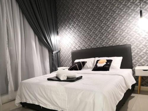 a bedroom with a large white bed with white sheets at Legoland D'PRISTINE Apartment By TGP in Nusajaya