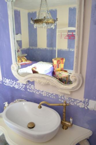 a bathroom with a sink and a mirror on the wall at La maison delle favole in Desenzano del Garda