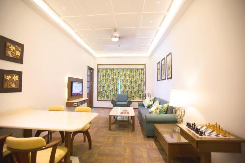 a living room with a chess board and a couch at E Square The Fern, Pune in Pune