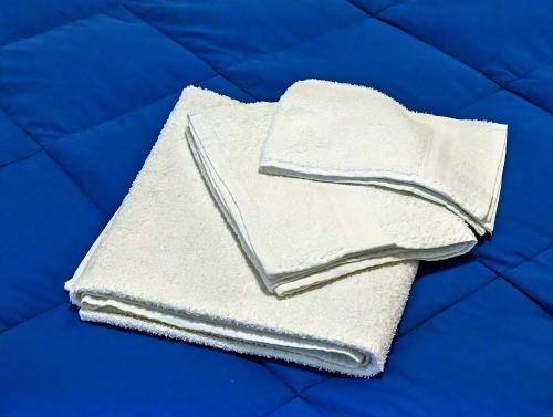 a pile of white towels sitting on a bed at Villa Magnolia in Bolsena