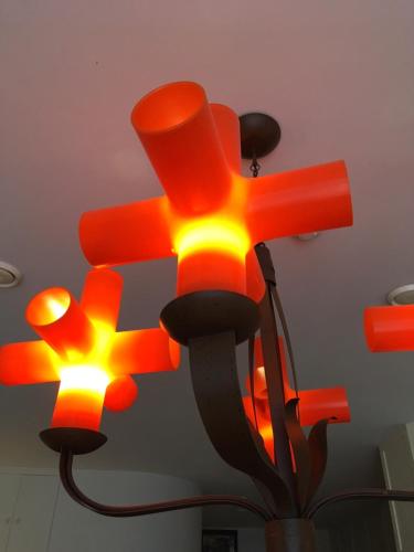 a ceiling light with orange and yellow lights on it at B&B Geste d' Alice in Middelkerke