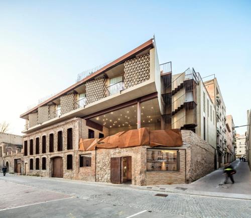 a person riding a skateboard in front of a building at Somiatruites in Igualada